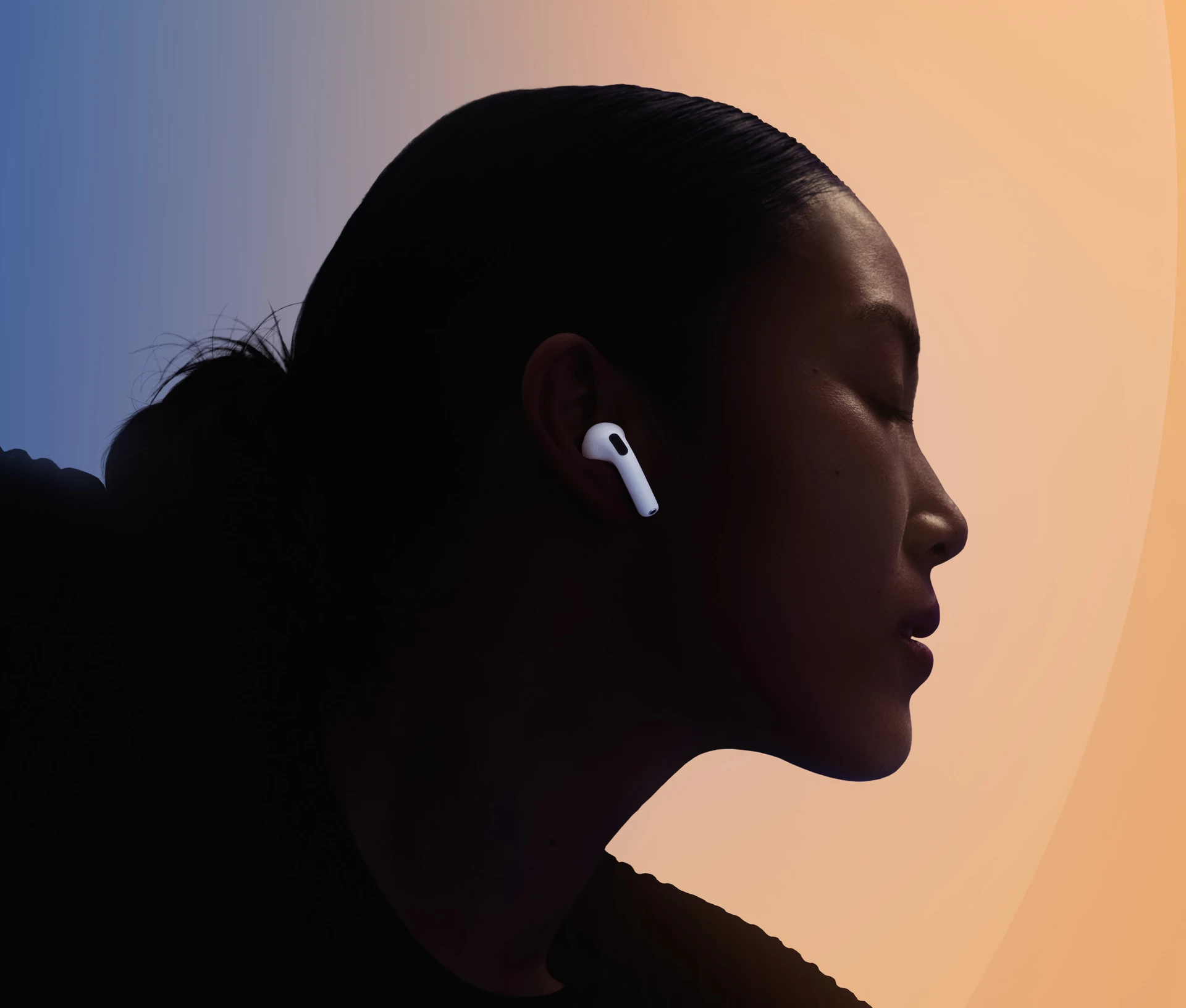 A person dancing while wearing AirPods 5, arms bent, multi-colour background